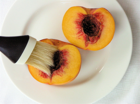 brushing Brush the peach halves with olive oil for grilling